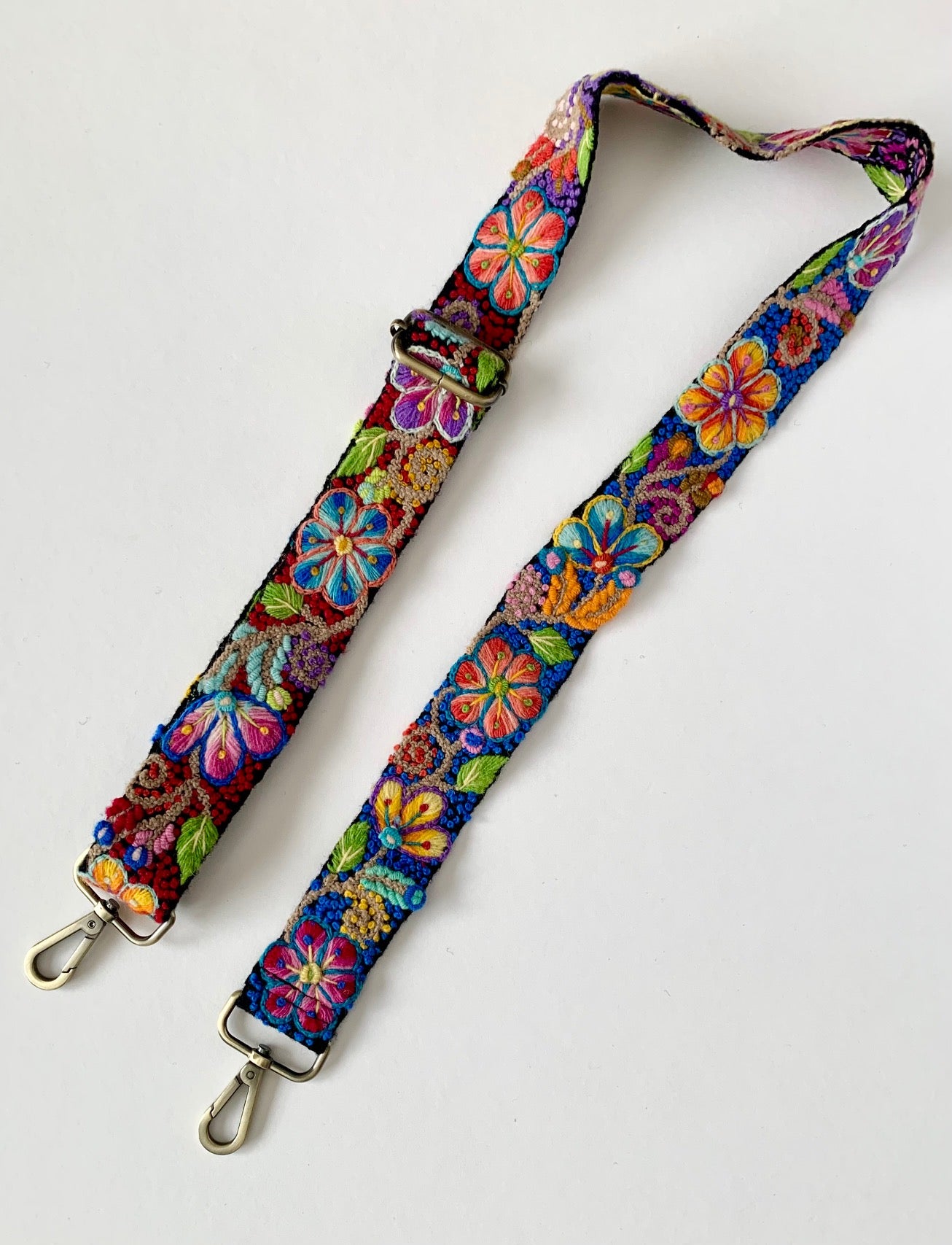 Black Floral Strap with bright floral hand embroidery, close-ups of flowers and buckle, fashion accessory lanyard connector.