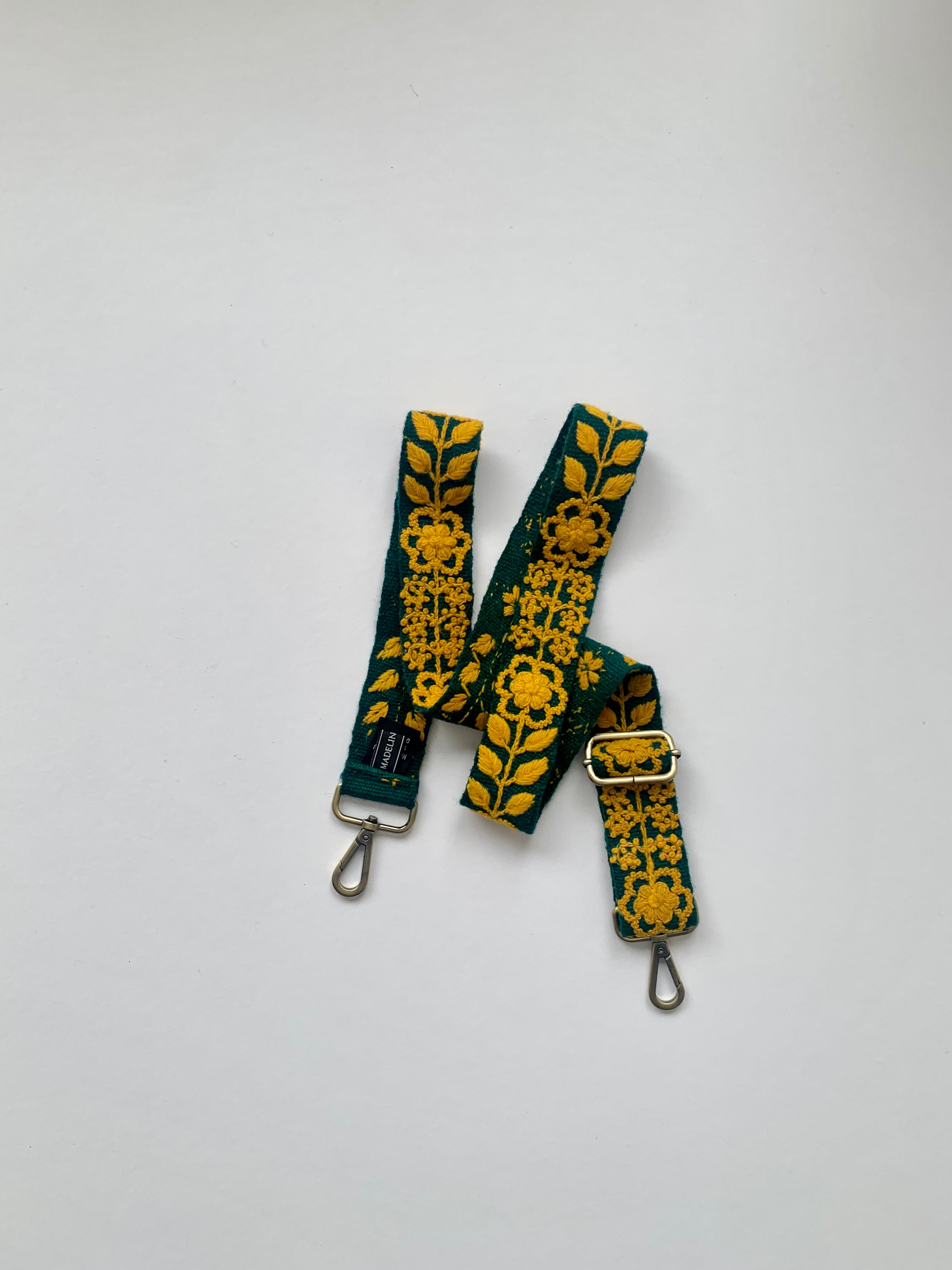 Alison Adjustable Purse Strap, a green and yellow strap with metal clasps