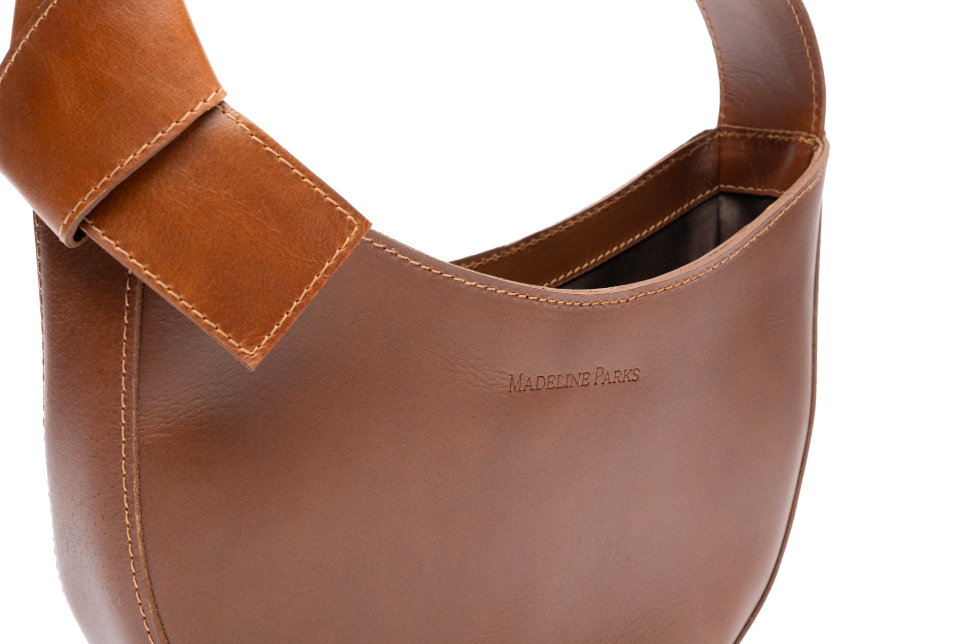 Stylish fashionable crescent shaped supple brown leather purse with bow that is fair trade .