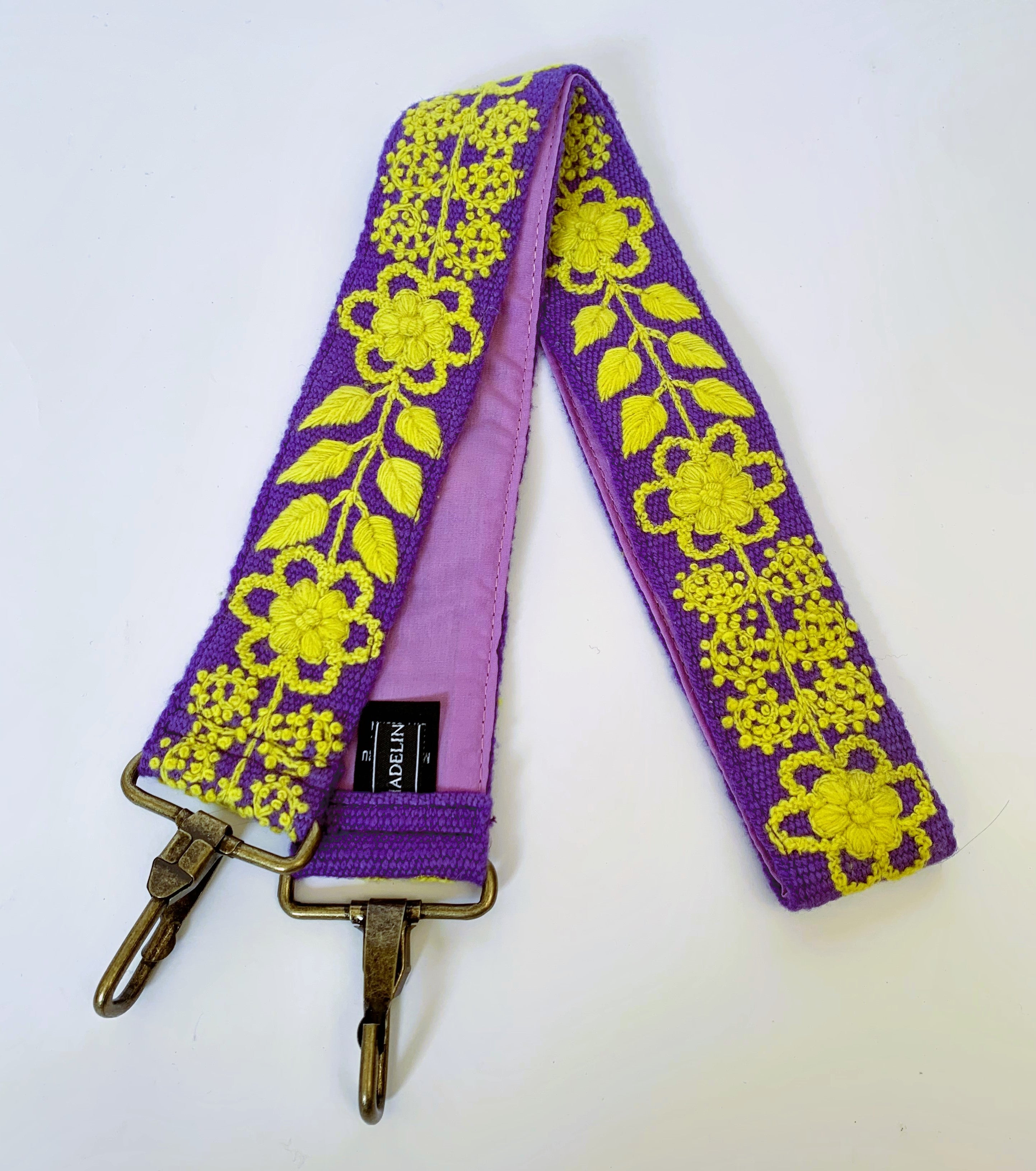 Purple and gold strap with metal clasps, featuring a floral and leaf design