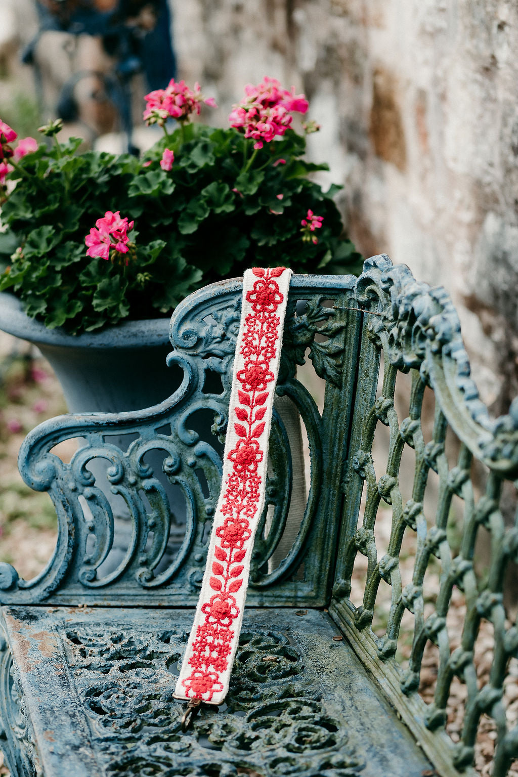 Abbey Large Purse Strap displayed on a bench in an outdoor setting.