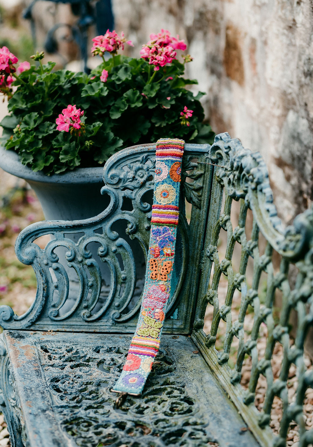Butterfly Large Strap on a bench, showcasing a colorful floral design.