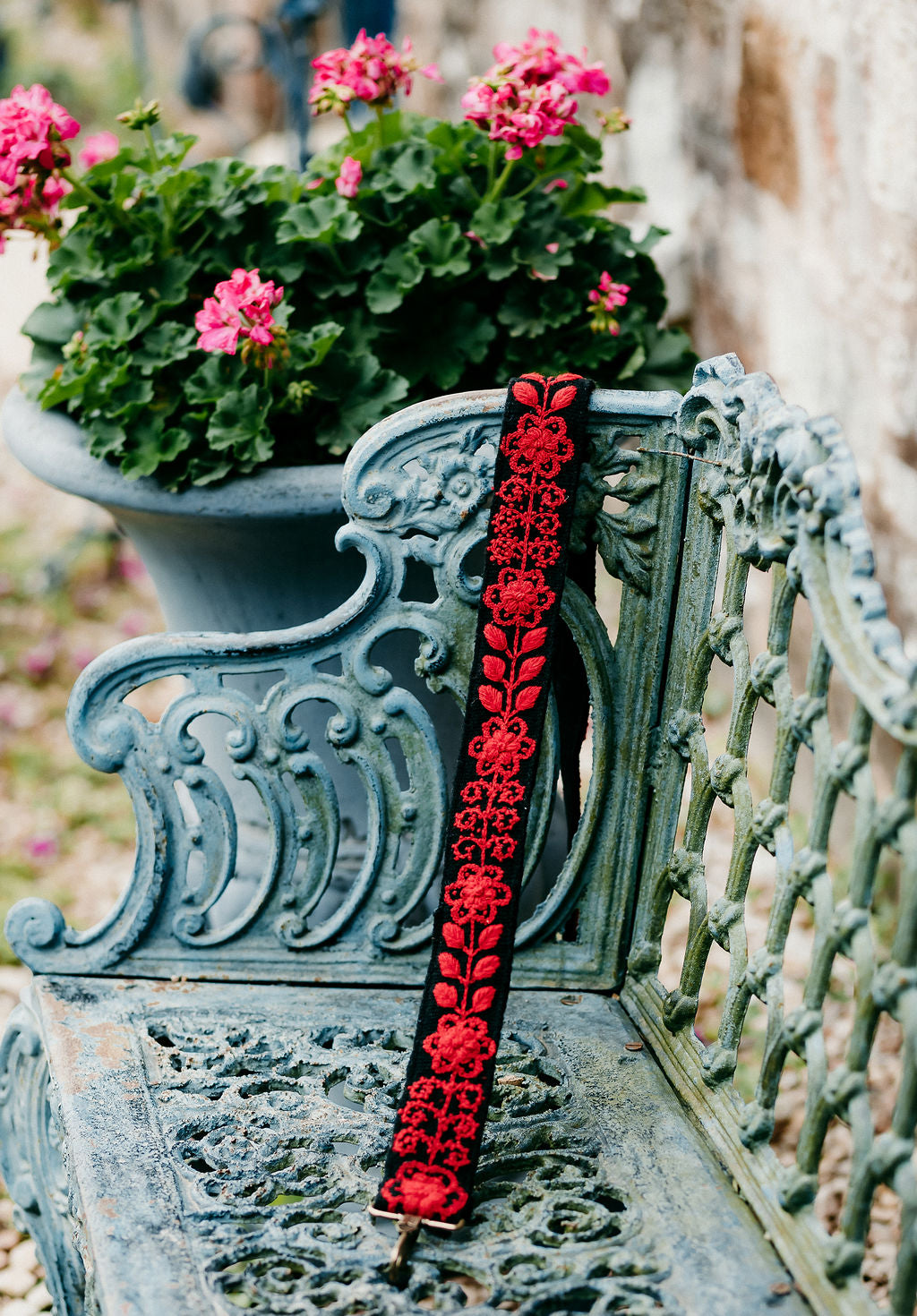 Kennedi Large Purse Strap displayed on a bench in an outdoor setting.