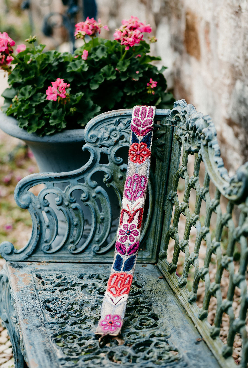 Purple Large Purse Strap displayed on a bench in an outdoor setting.