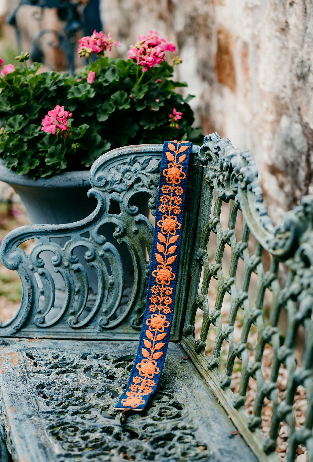 Kenley Large Purse Strap displayed on a bench in an outdoor setting.