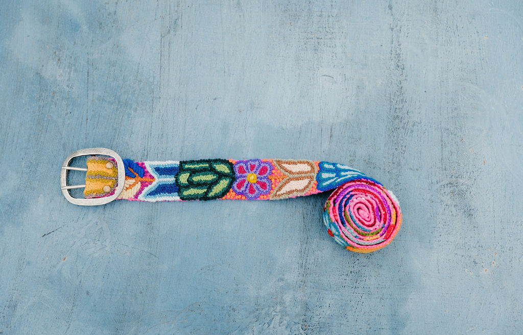 Hot Pink Embroidered Belt with Colorful Floral Design, displayed on blue background.