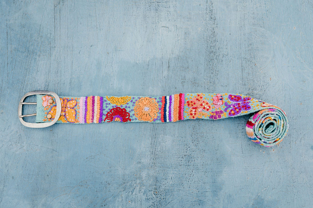 Floral butterfly belt design displayed on blue background.