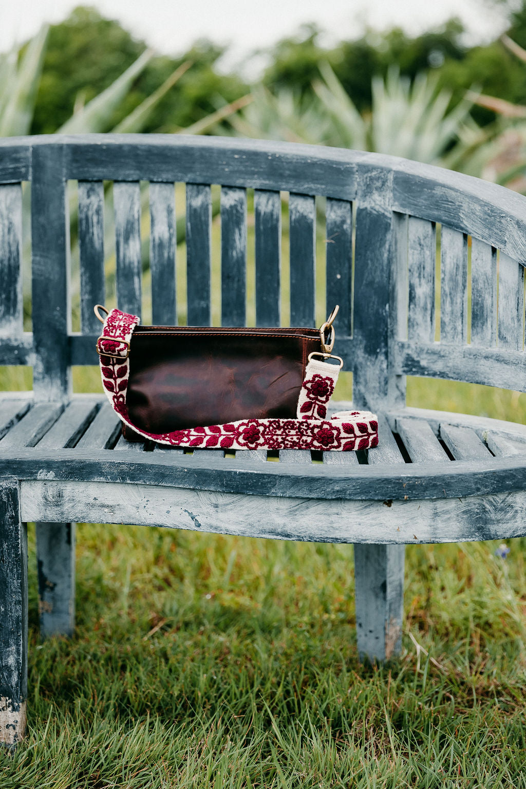 Wendi Adjustable Strap featuring a purse on a bench, hand-embroidered in Peru. Perfect for showing school pride or game day.