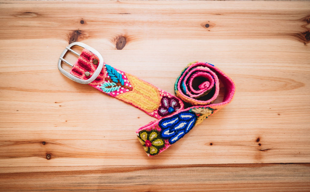 Hot Pink Embroidered Belt on Wooden Surface - Hand loomed wool fabric with bright floral and leaves. Fair trade artisan-made in Peru. Sizes: S (35"), M (41"), L (47"), XL (50").