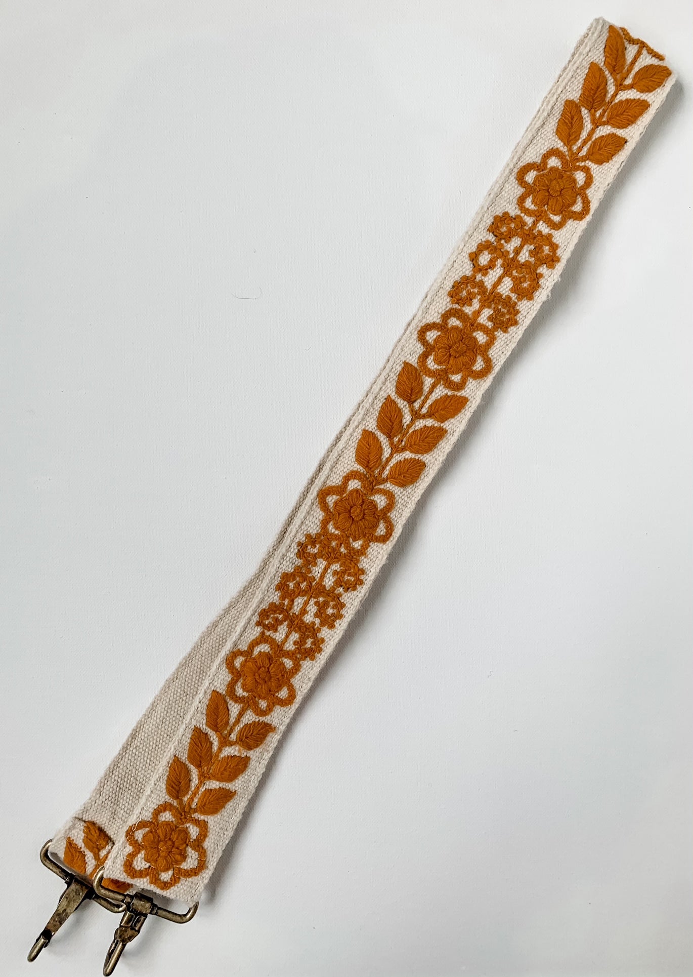 Rachel Large Purse Strap with a dark orange floral and leaf pattern.