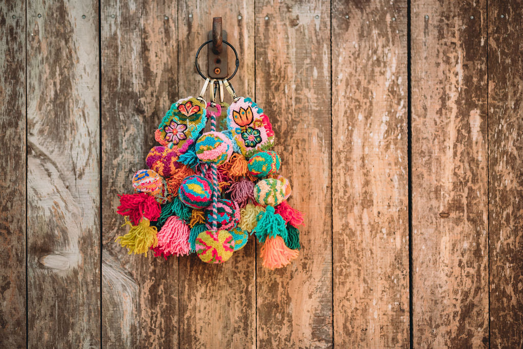 A collection of colorful hand embroidered tassels from fair trade artisans in the mountains of Peru from Madeline Parks Designs.
