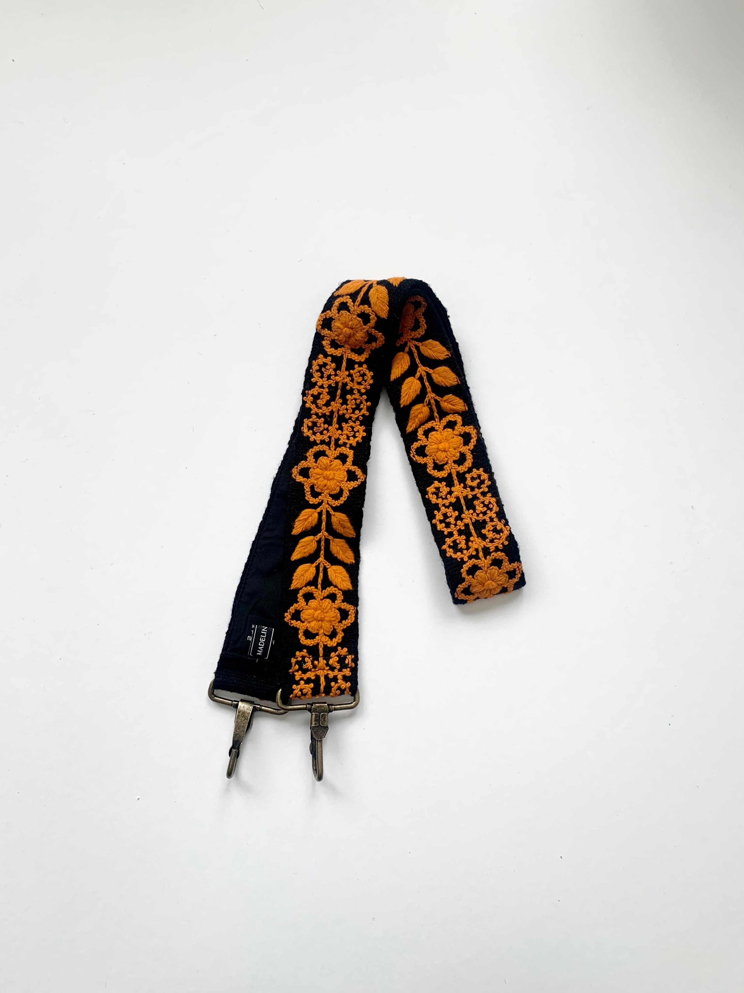 Hand embroidered and woven black wool fabric with orange floral and leaves design