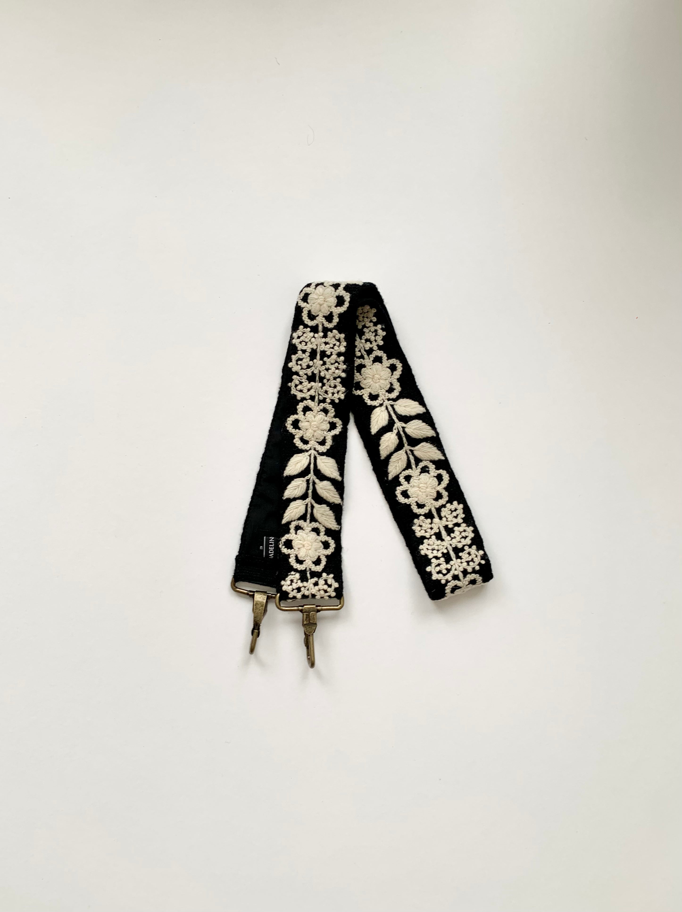 Black and white strap with delicate floral embroidery
