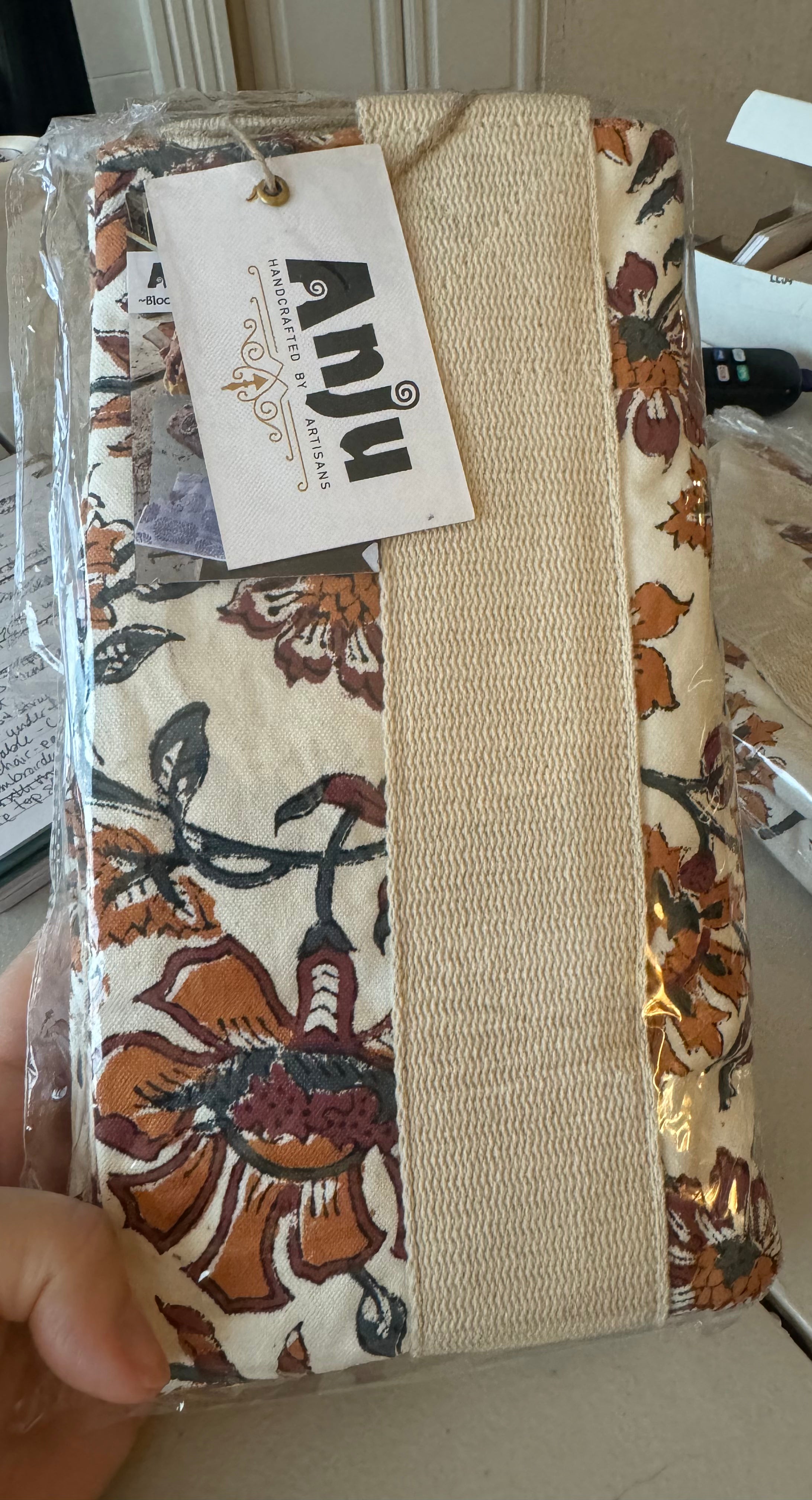 Hand holding a Block Printed Canvas Bag with a white tag, showcasing detailed hand-printed fabric.