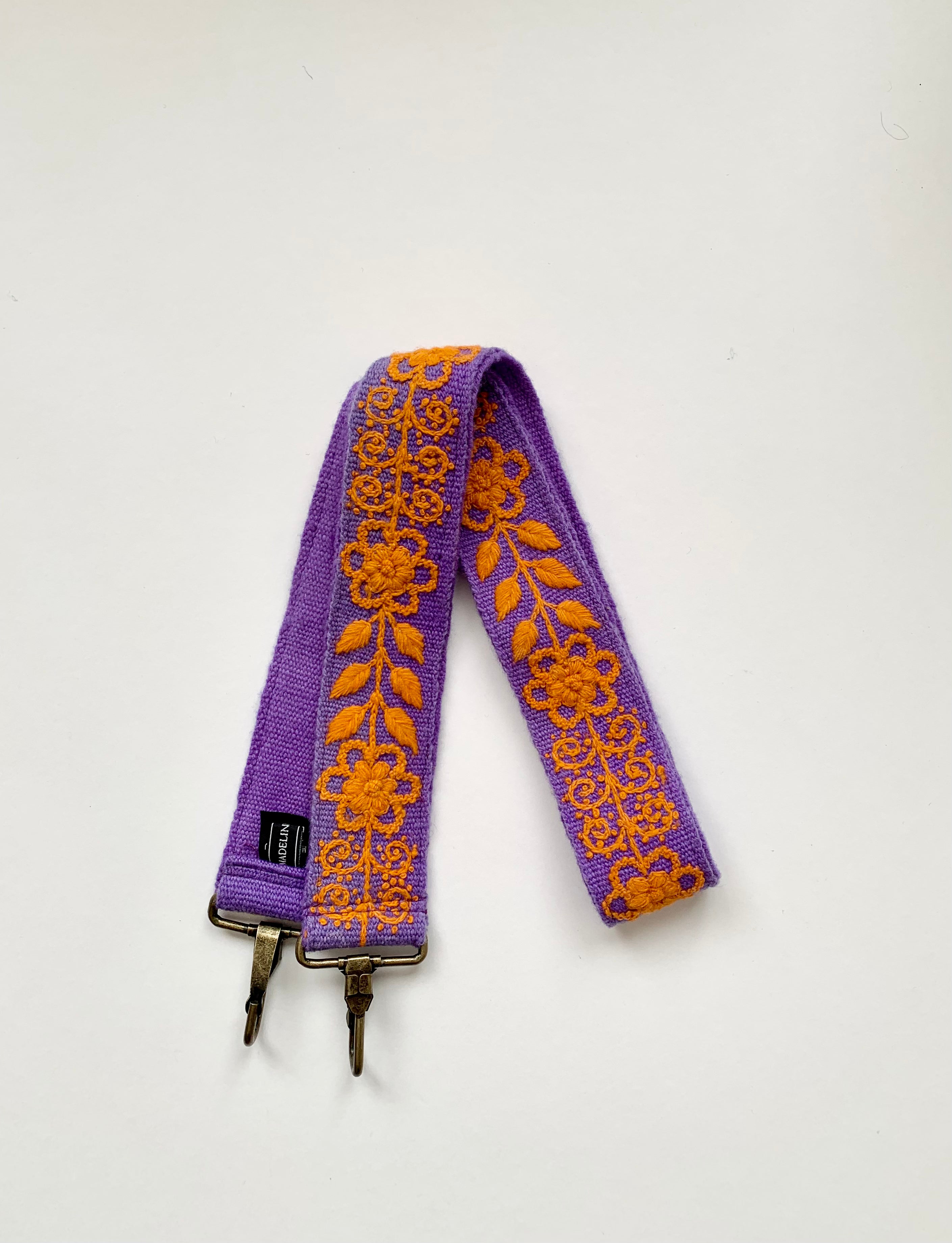 Katy Large Purse Strap: Hand-loomed wool fabric with purple backing and orange floral and leaves design, non-adjustable. Hand embroidered by Fair Trade artisans.