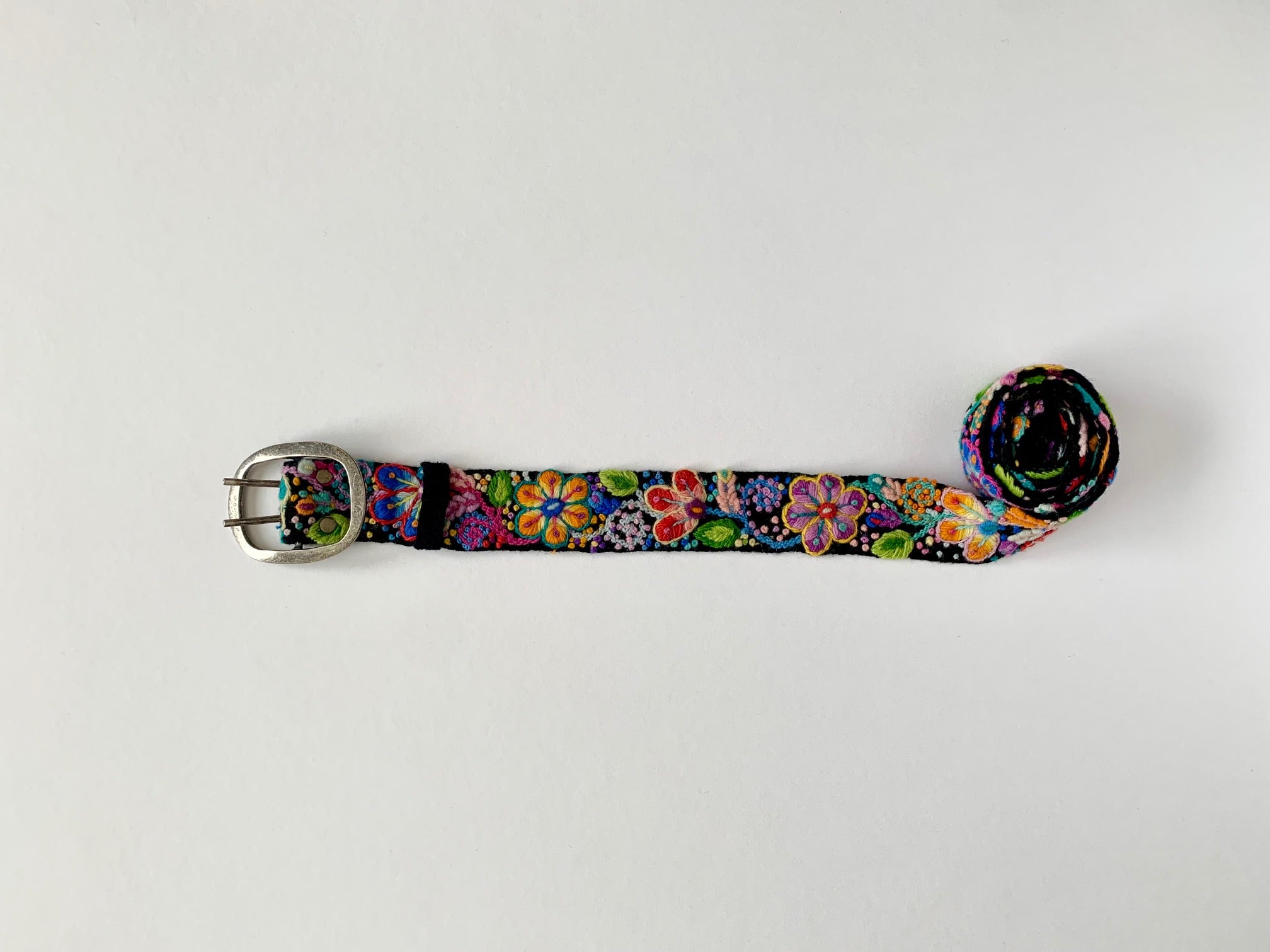 Black Floral Belt with colorful flower embroidery and metal buckle, hand loomed wool fabric from Peru. Sizes: S, M, L, XL.