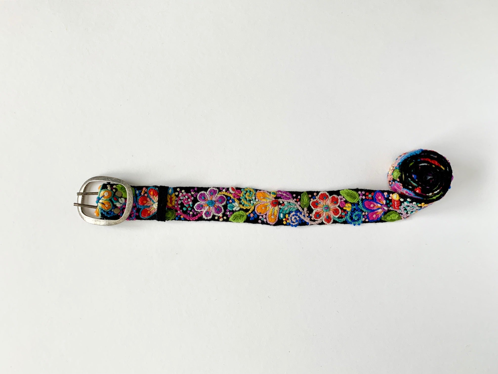 Black Floral Belt with colorful embroidered florals and butterfly on hand loomed wool fabric. Sizes: Small, Medium, Large, Extra Large.