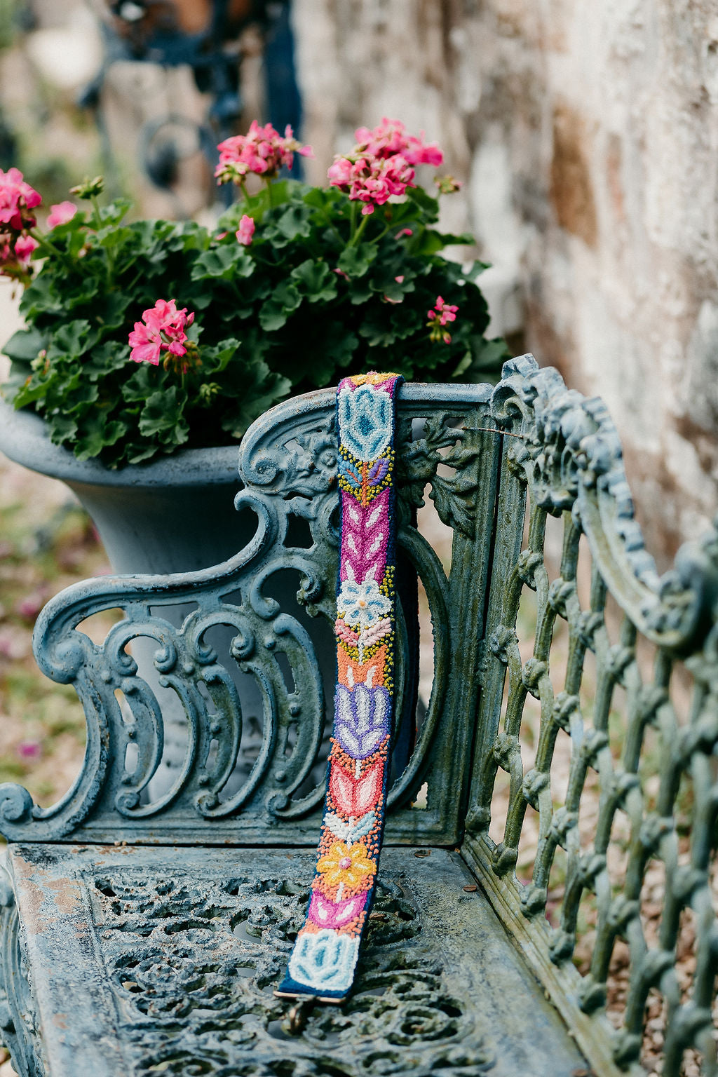 Navy Floral Large Strap displayed on a bench in an outdoor setting.