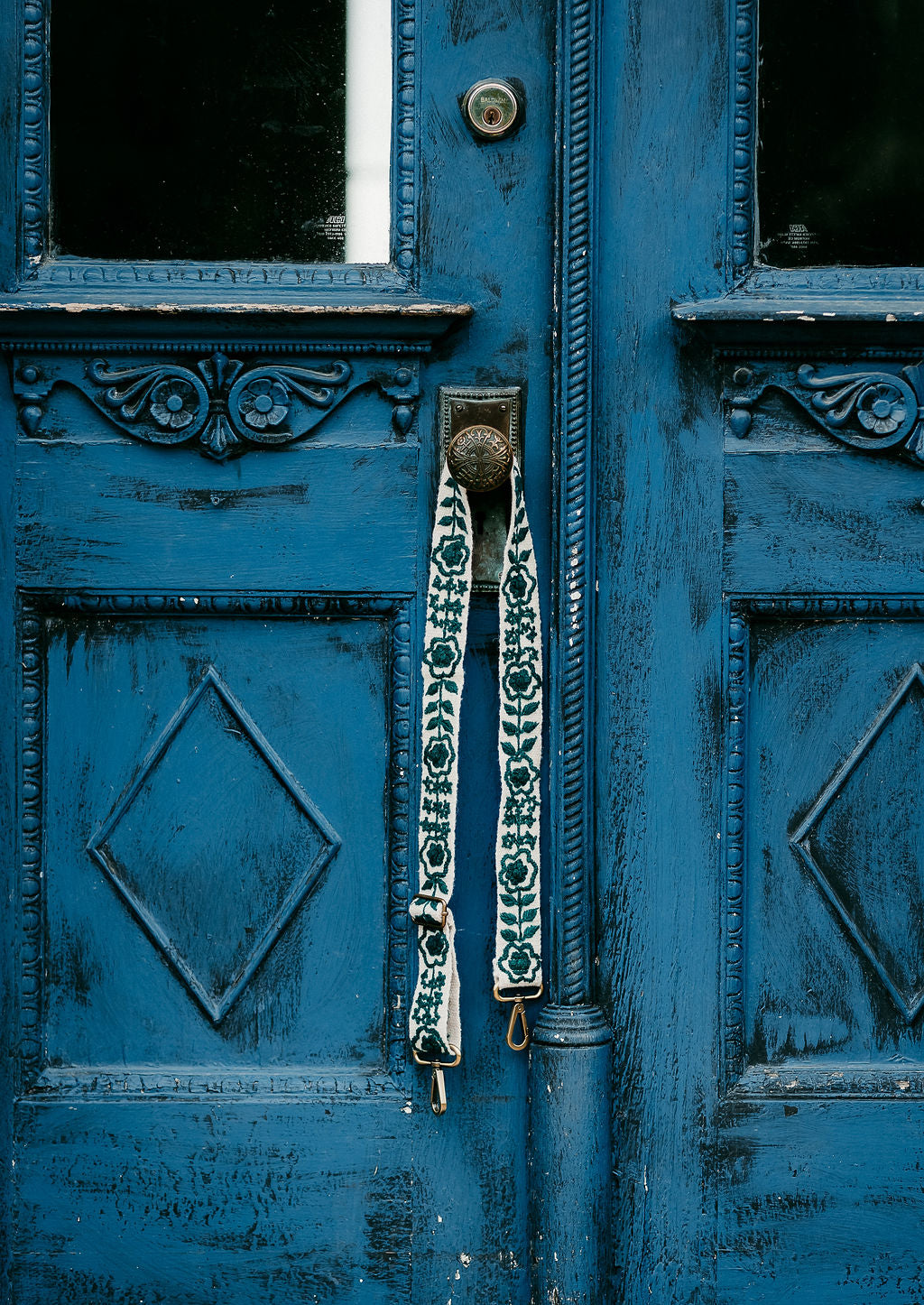 Jill Adjustable Strap displayed on a blue door