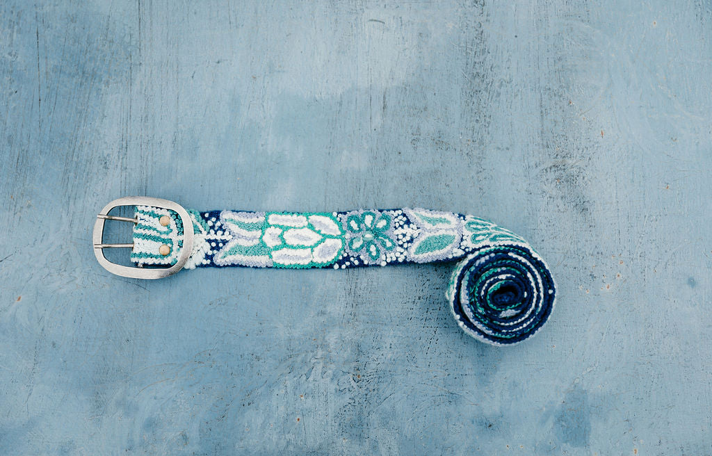 Blues Embroidered Belt with Silver Buckle, handcrafted by fair trade artisans in Peru displayed on blue background.