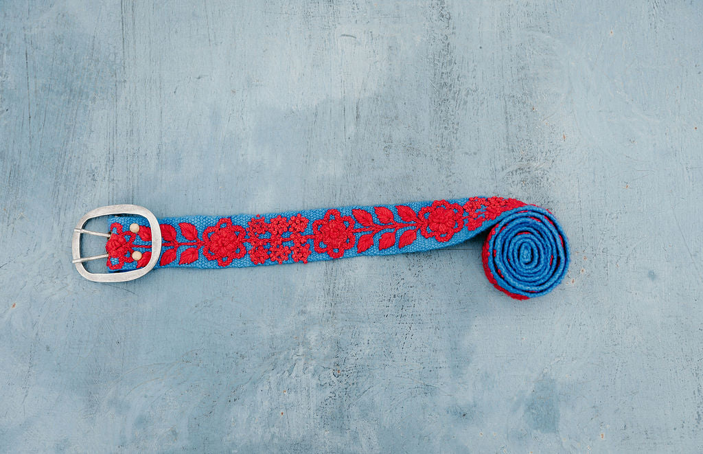 Taylor Hand Embroidered Belt: Navy wool fabric with red floral and leaves embroidery displayed on blue background.