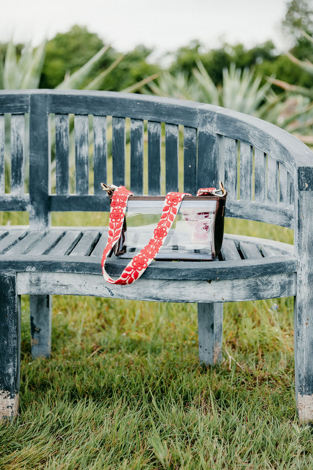 Abbey Adjustable Strap displayed on a bench in an outdoor setting. 