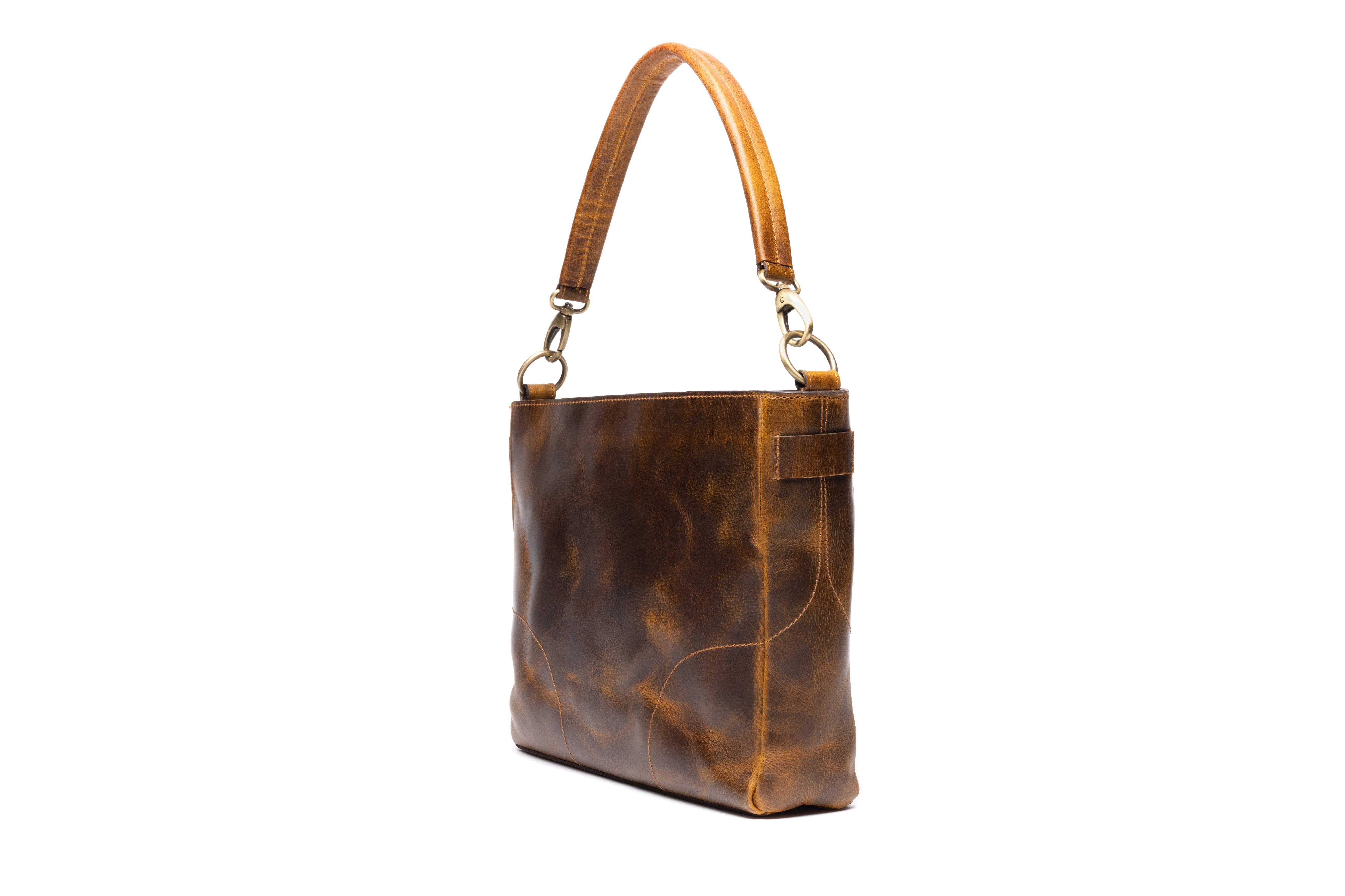 Catherine Leather Purse: A large brown leather bag with a handle and straps. 