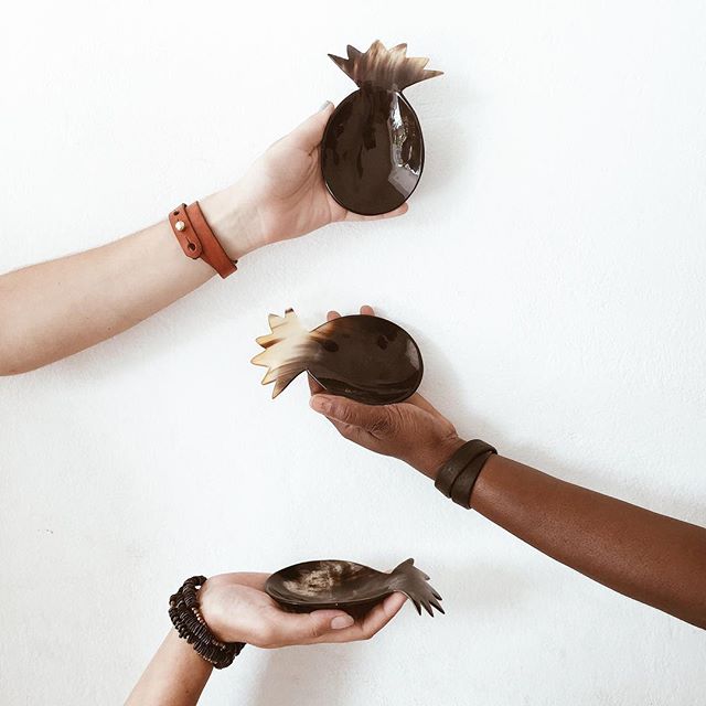 A group of hands holding a Pineapple Horn Bowl